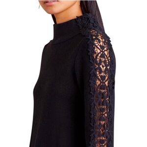 Anthropologie knitted and knotted mock neck Lace flare Sleeve black sweater